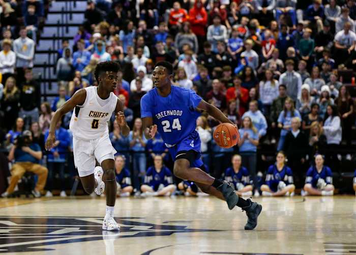 Greenwood's Aminu Mohammed drives downcourt as Kickapoo's Anton Brookshire chases him during the Gold Division championship game in the Blue and Gold Tournament on Monday, Dec. 30, 2019.